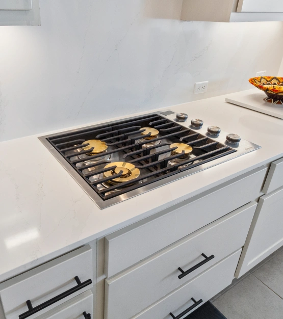 Gas stovetop in modern white kitchen. Kitchen Remodel in Pflugerville, TX.