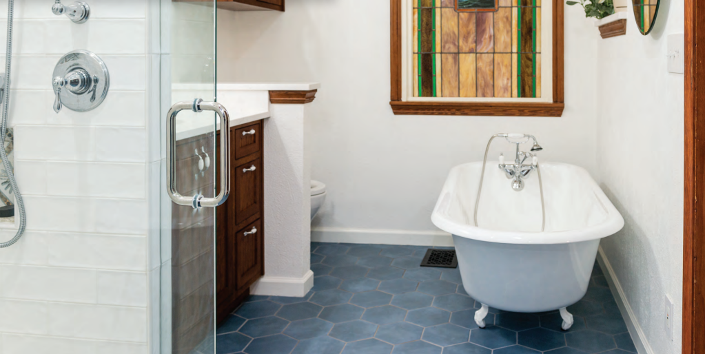 A bathroom featuring a shower and a bathtub, showcasing a clean and modern design. Bathroom renovation project in Buda, TX.