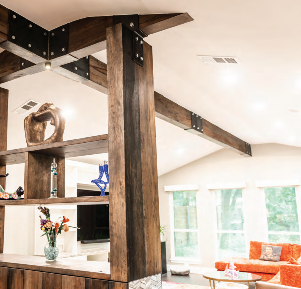 Rustic wooden beam structure with metal brackets, supporting shelves and a view into a bright living area.  Dining and Living Room Renovation in Austin, TX.
