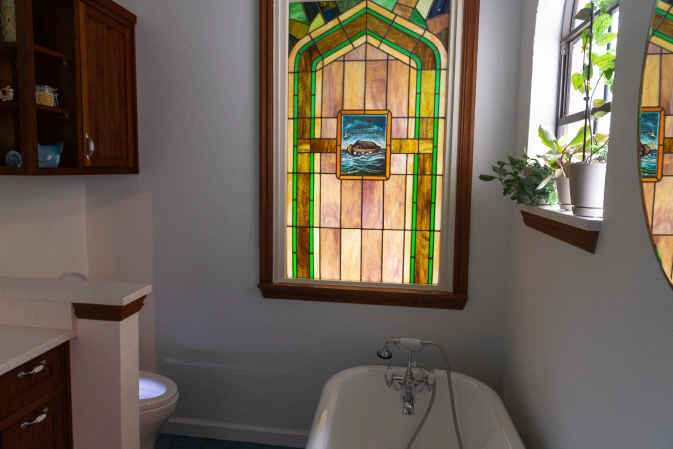 Bathroom with a stained glass window. Bathroom renovation project in Buda, TX.