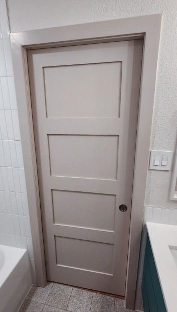 Light-colored door for the bathroom. Bathroom renovation project in Austin, TX.